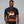 Man wearing a black t-shirt with 'Hoppy Thanksgiving' design on a gray background