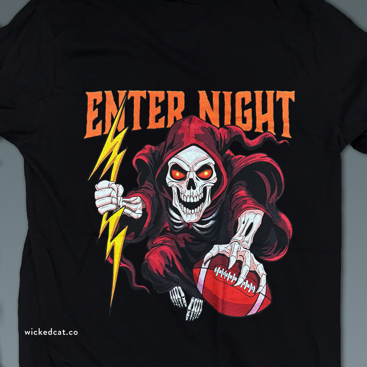 Black va tech football t-shirt with a graphic design of a skeleton in a red hood holding a football and lightning bolt, with 'Enter Night' text.