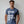 Person wearing a black t-shirt with 'WTF Funny Sarcastic' design on a plain background