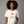 Person wearing a dark gray t-shirt with 'American Woman Patriotic Martini July 4th' design on a plain background