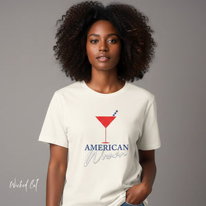 Person wearing a dark gray t-shirt with 'American Woman Patriotic Martini July 4th' design on a plain background