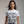 Person wearing a red t-shirt with 'Batman Joker Quote Funny' design on a plain background