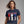 Person wearing a black t-shirt with 'Patriotic Fashion July 4th' design on a plain background