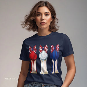 Person wearing a black t-shirt with 'Patriotic Fashion July 4th' design on a plain background