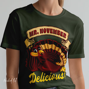Person wearing a dark gray t-shirt with 'Mr. November Turkey Funny Thanksgiving' design on a plain background